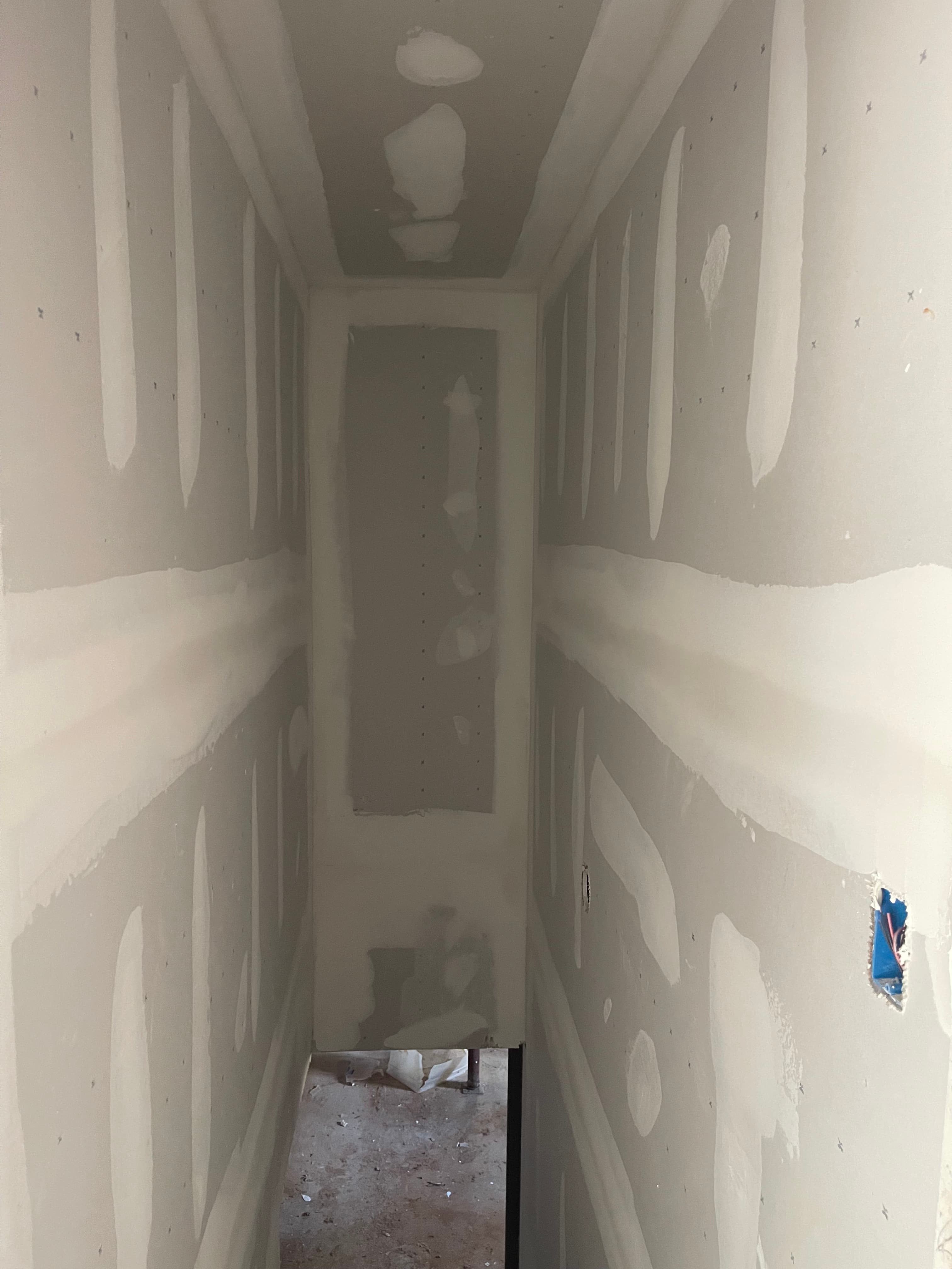 Drywall Finishing and Preparation in Narrow Hallway