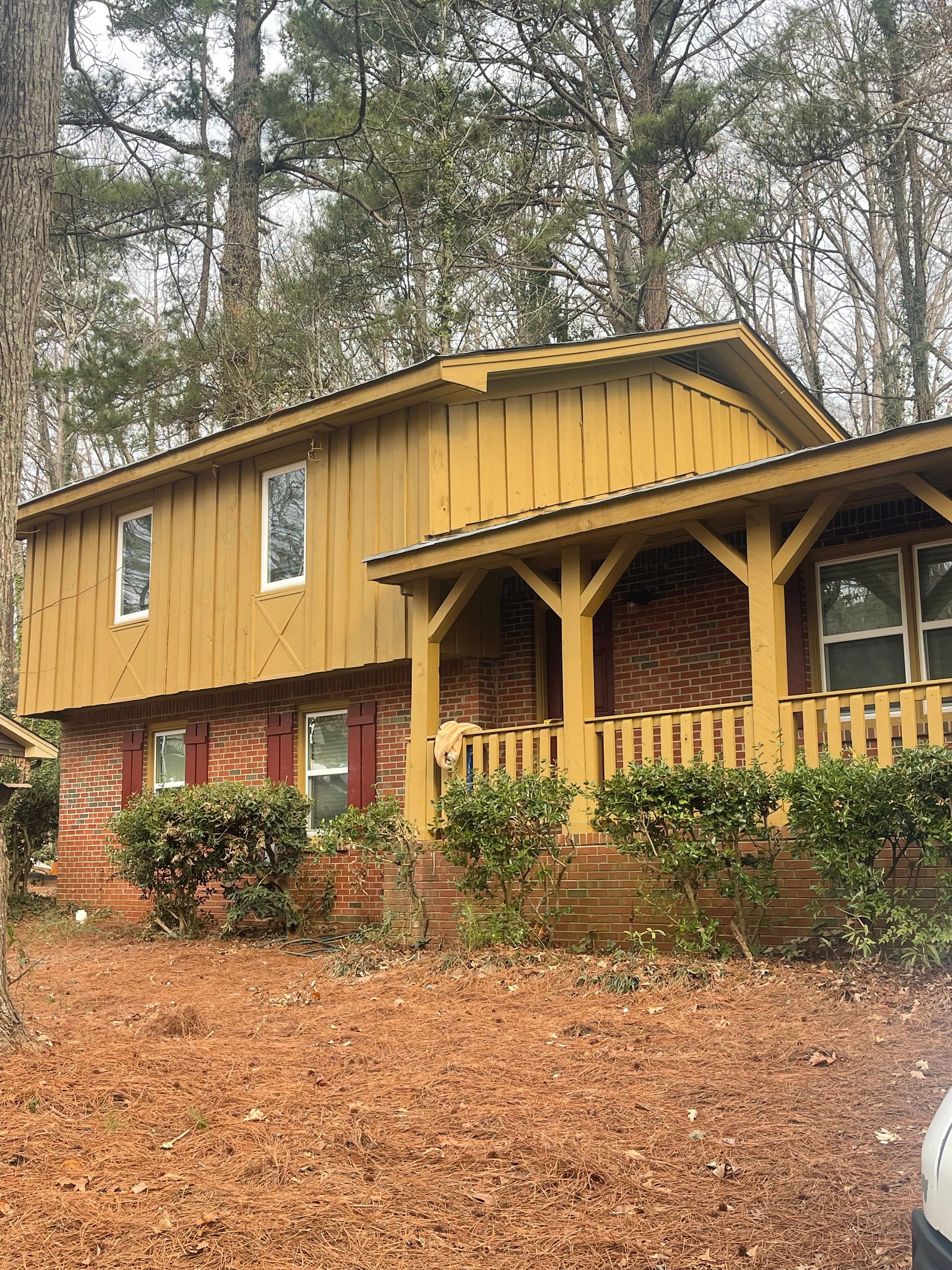 Split-Level Exterior Refresh with Yellow Trim & Metal Accents